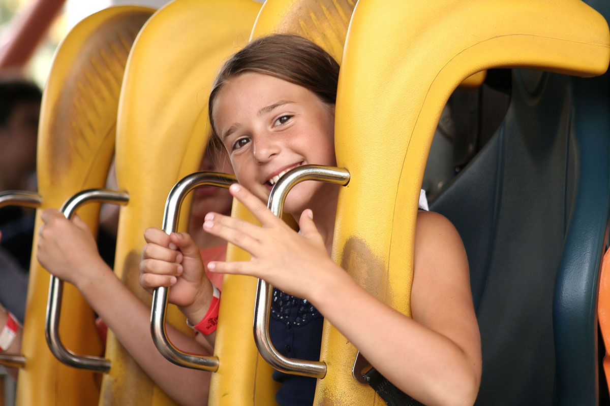 A girl sits in a rollercoaster seat
