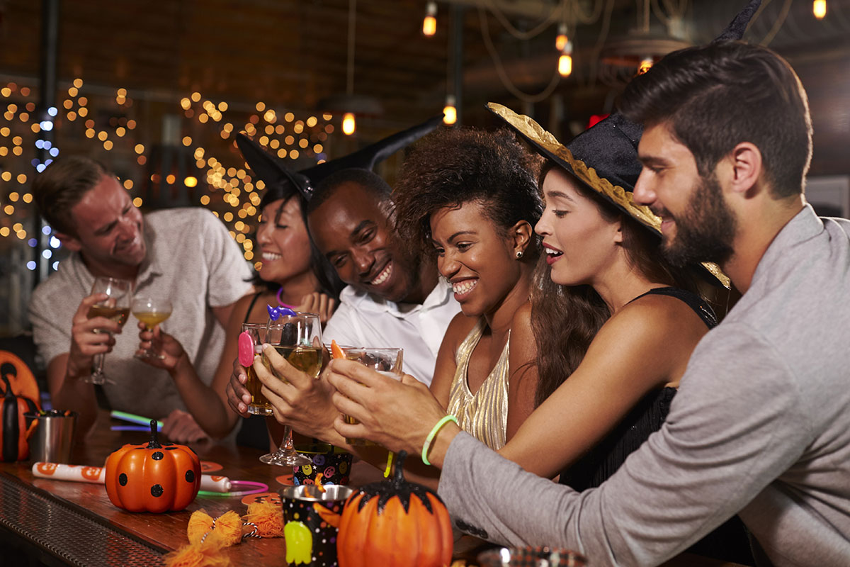 Friends enjoy a drink together at a Halloween party