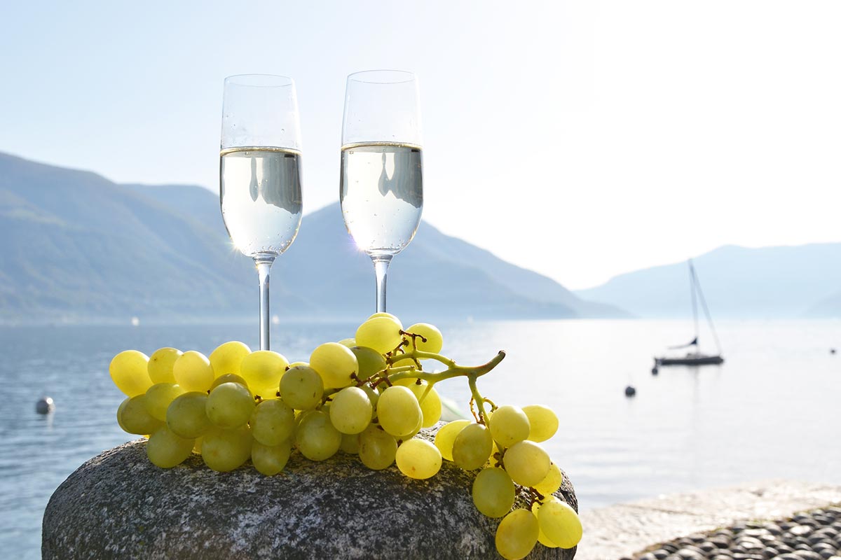 Two glasses with grapes by Lake Maggiore