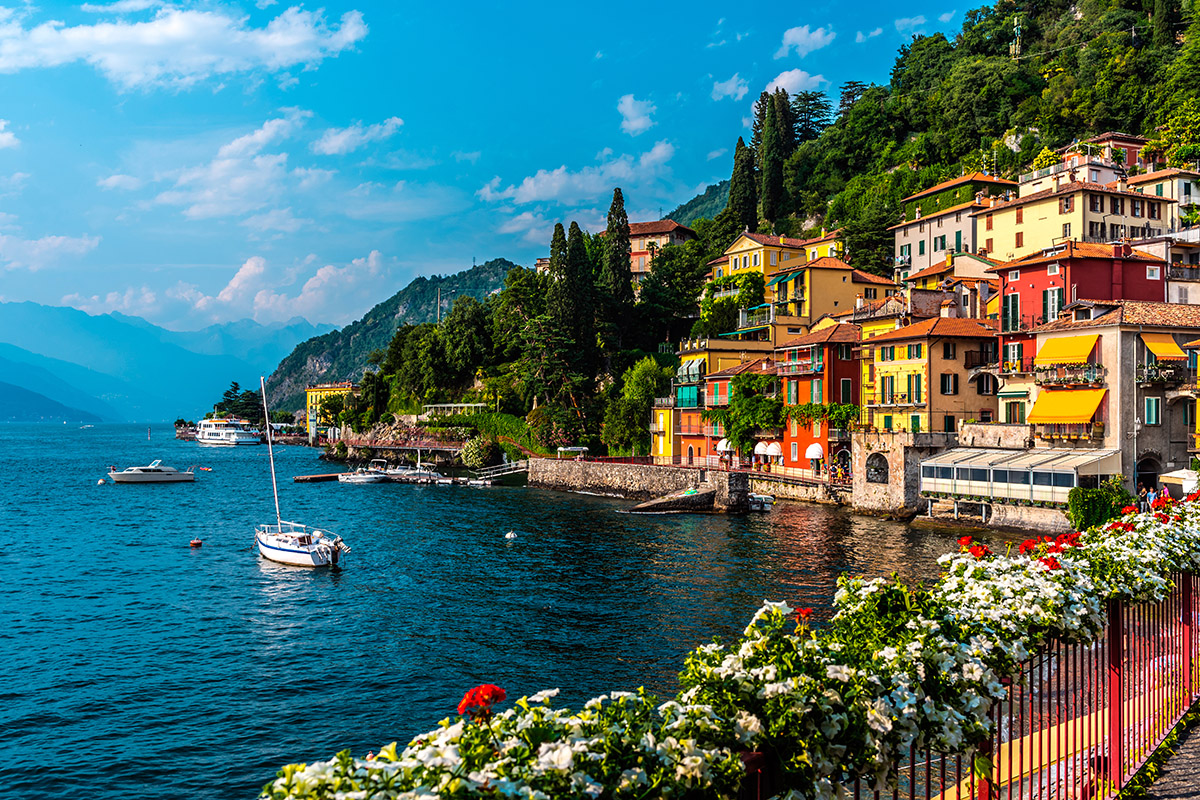  A lakeshore view of Varenna, a centrally-located lake town on Lake Como, with vibrant houses and boats