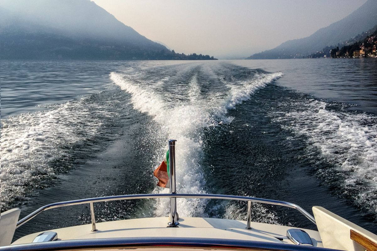 A motorboat gliding through an Italian lake