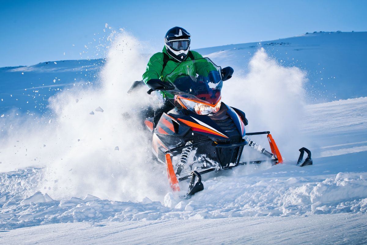 A tourist enjoying snowmobiling, an off-the-piste snow sport