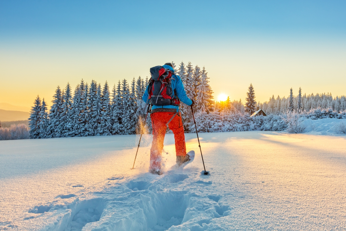 Man snow shoeing during sunset