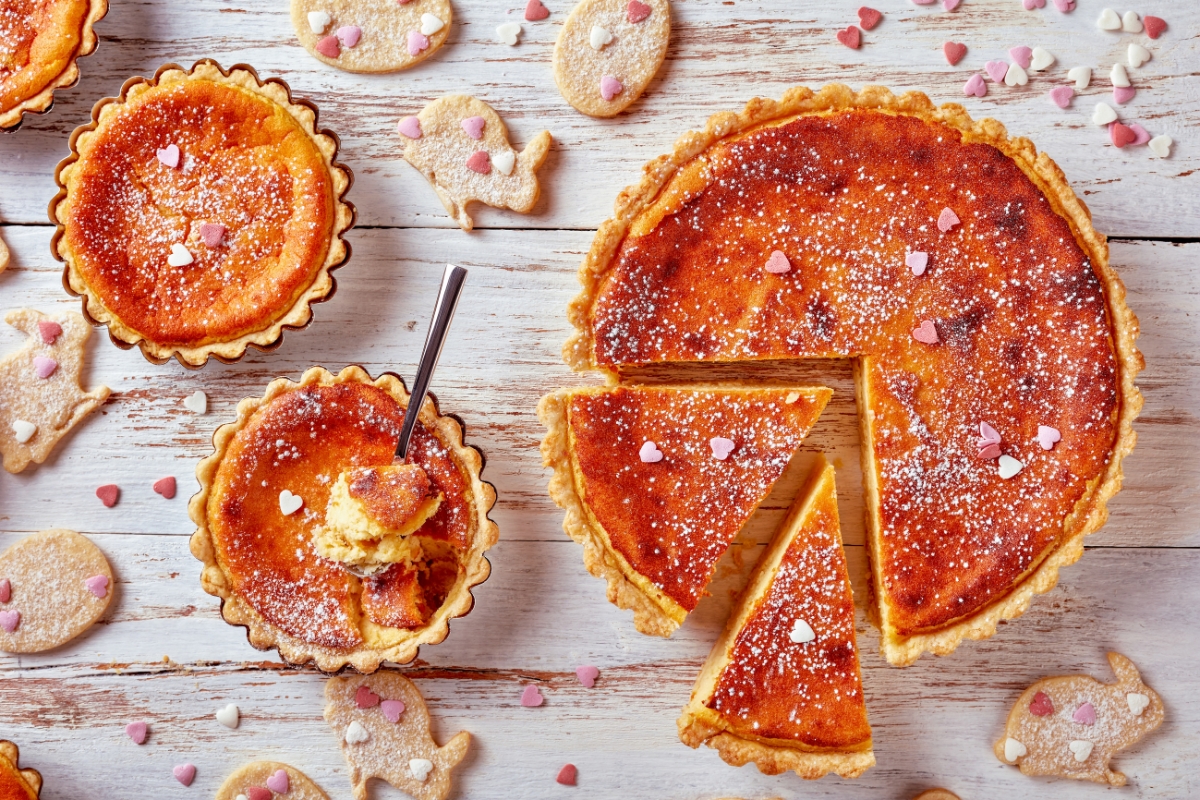 A table full of Osterfladen, a typical Easter tart made of rice with Easter cookies