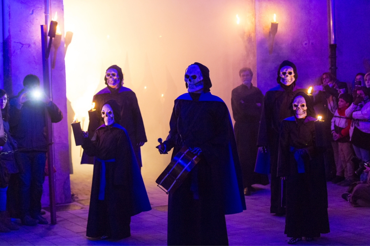 Adults and children take part in The Dance of Death, an Easter Celebration from Verges, Spain