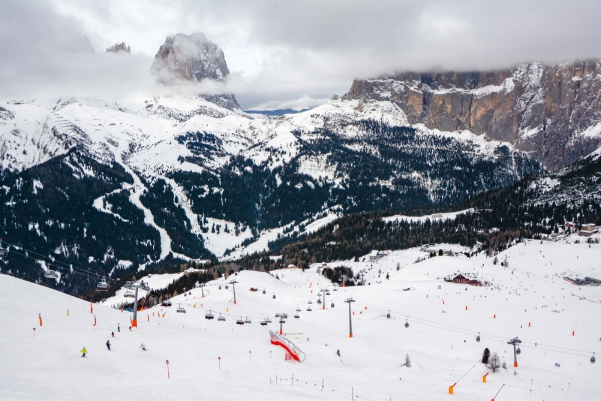 Snow clouds have gathered over the mountains of Val Di Fassa. Italian ski resort in winter. Skiing area in the Dolomites Alps.