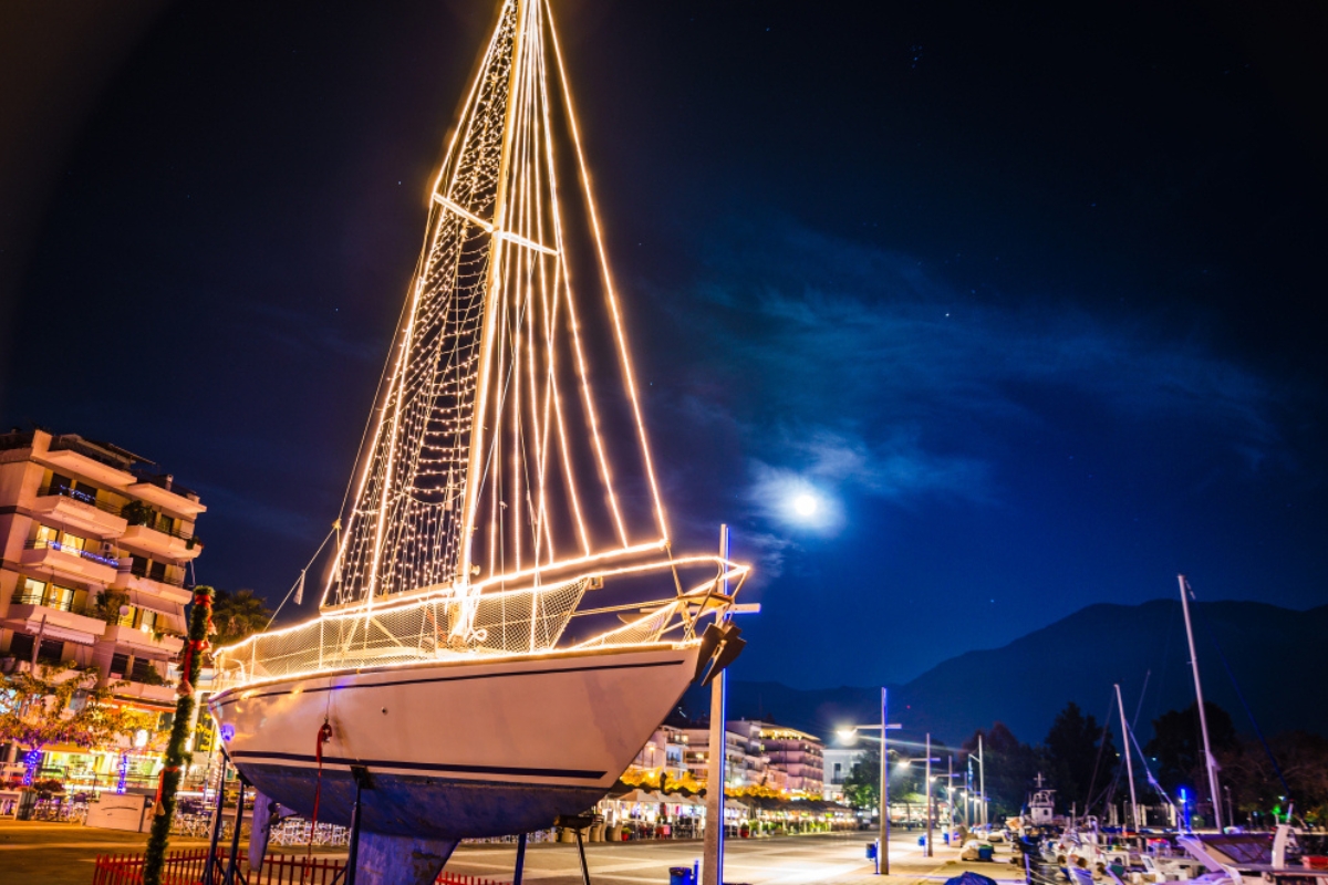 Greece's Christmas tradition of lighting up wooden boat replicas along with Christmas trees.