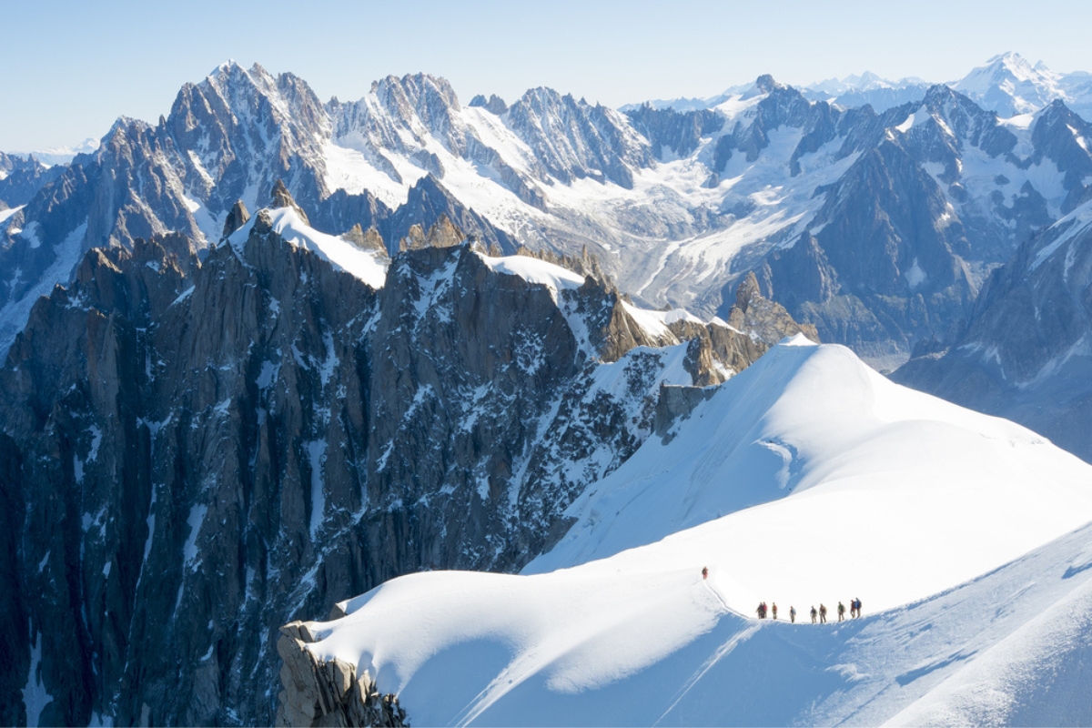 A group of hikers walk through the snow on Mont Blanc