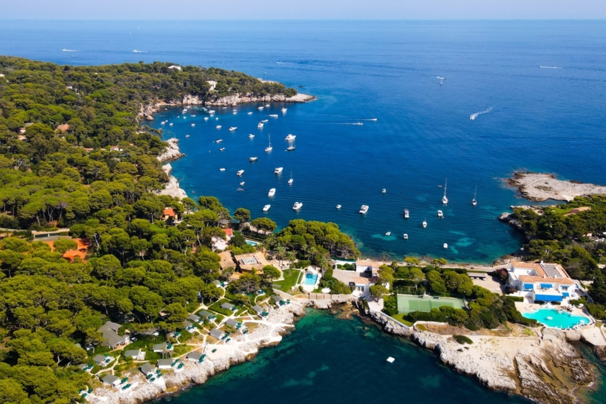 Aerial view of Cap d'Antibes and Billionaire's Bay Aerial view of Cap d'Antibes and Billionaire's Bay. Plage de l'argent faux. Beautiful rocky beach near coastal path on the Cap d'Antibes, Antibes, France. Drone view of Côte d’Azur