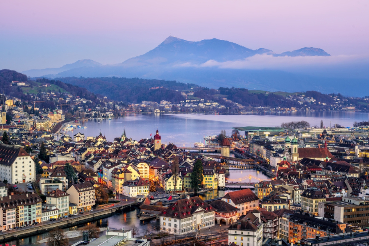 Aerial view of the old town of Lucerne, wooden chapel bridge, stone water tower, river Reuss, Rigi mountain and Lake Lucerne, Switzerland, at sunset