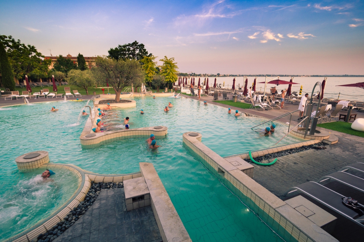 Aquaria, the Thermal Spa Center of Terme di Sirmione at sunset. A unique place, surrounded by the beautiful setting of Lake Garda.