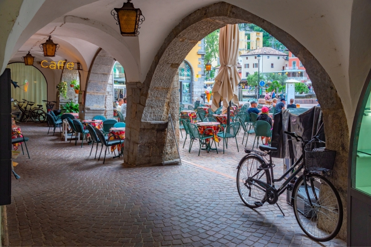 Arcade in the center of Italian town Riva del Garda with cafes around it