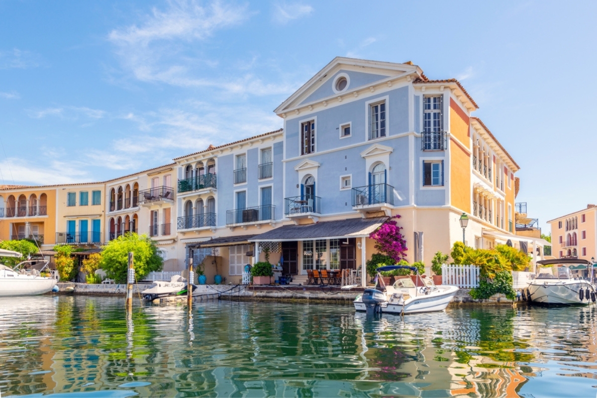 Colorful homes with boats and docks along the canals at the oceanfront community of Port Grimaud, France, along the French Riviera Cote d'Azur near Saint-Tropez