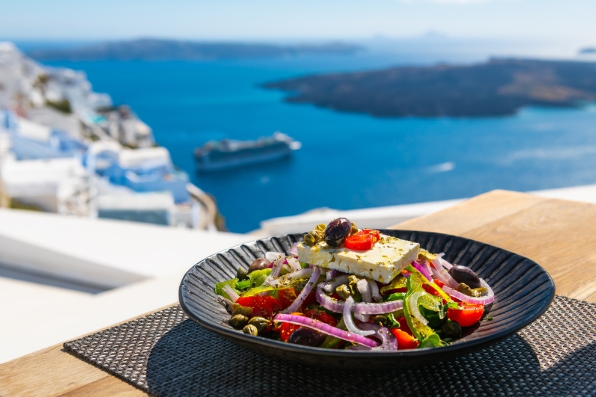 Greek salad with beautiful sea view in Santorini island, Greece