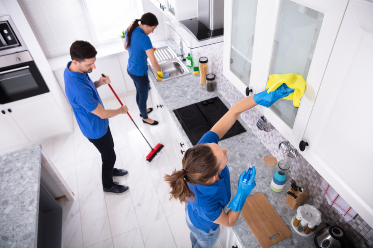 Group of cleaners in action wearing uniform