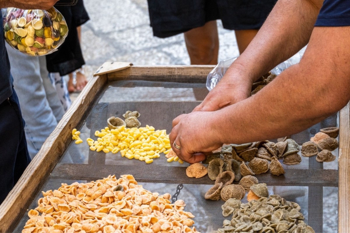 Hands serving typical italian pasta orecchiette handmade in Bari Puglia Italy