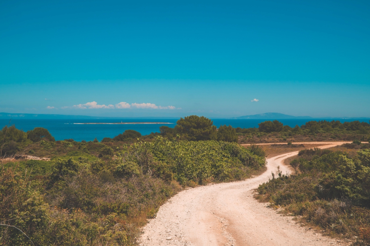 Wild landscapes with plants and gravel roads on the coast of Kamenjak National Park in Premantura, Istria, Croatia