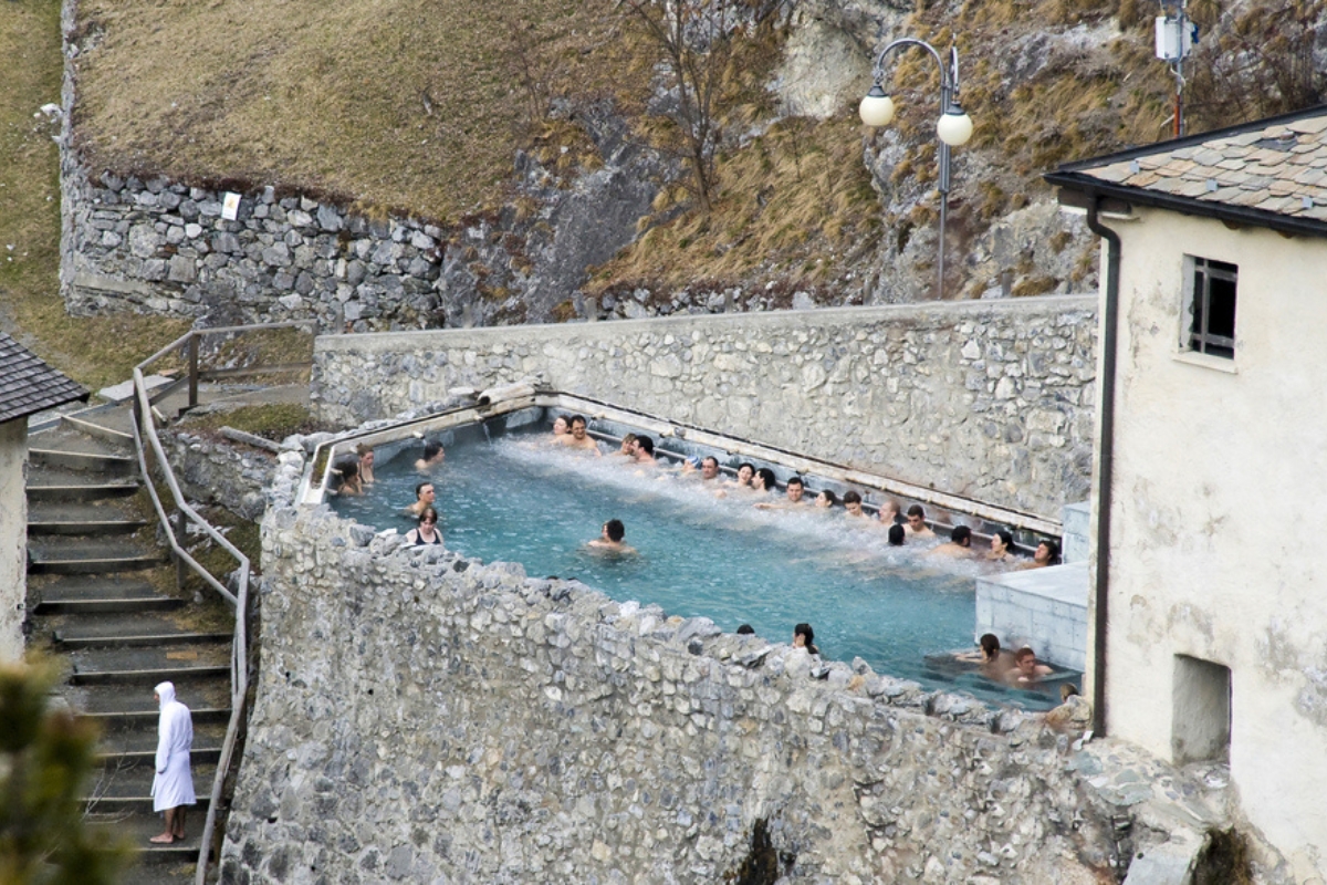 People relaxing at Bagni Vecchi in the outdoor swimming pools in Bormio, province of Sondrio