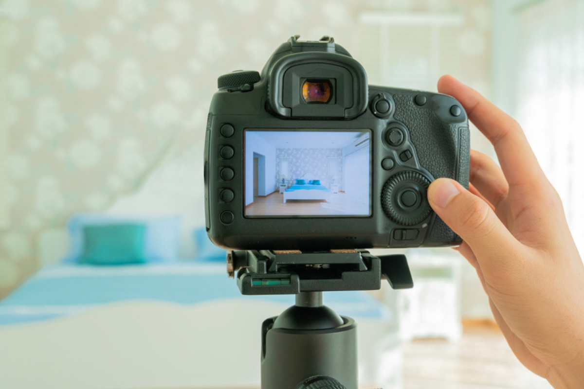 Photographer takes professional photos of a bedroom