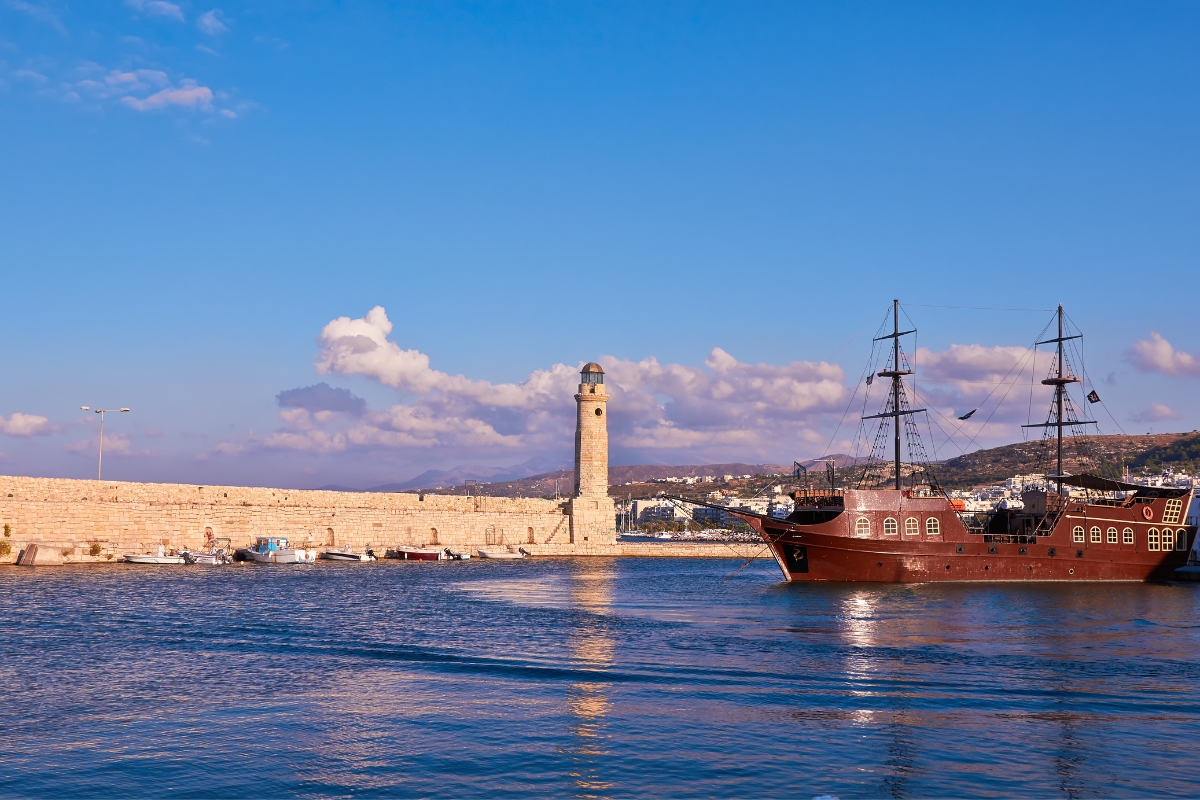 Rethymnon’s ancient venetian harbour and lighthouse, with an old boat on the right