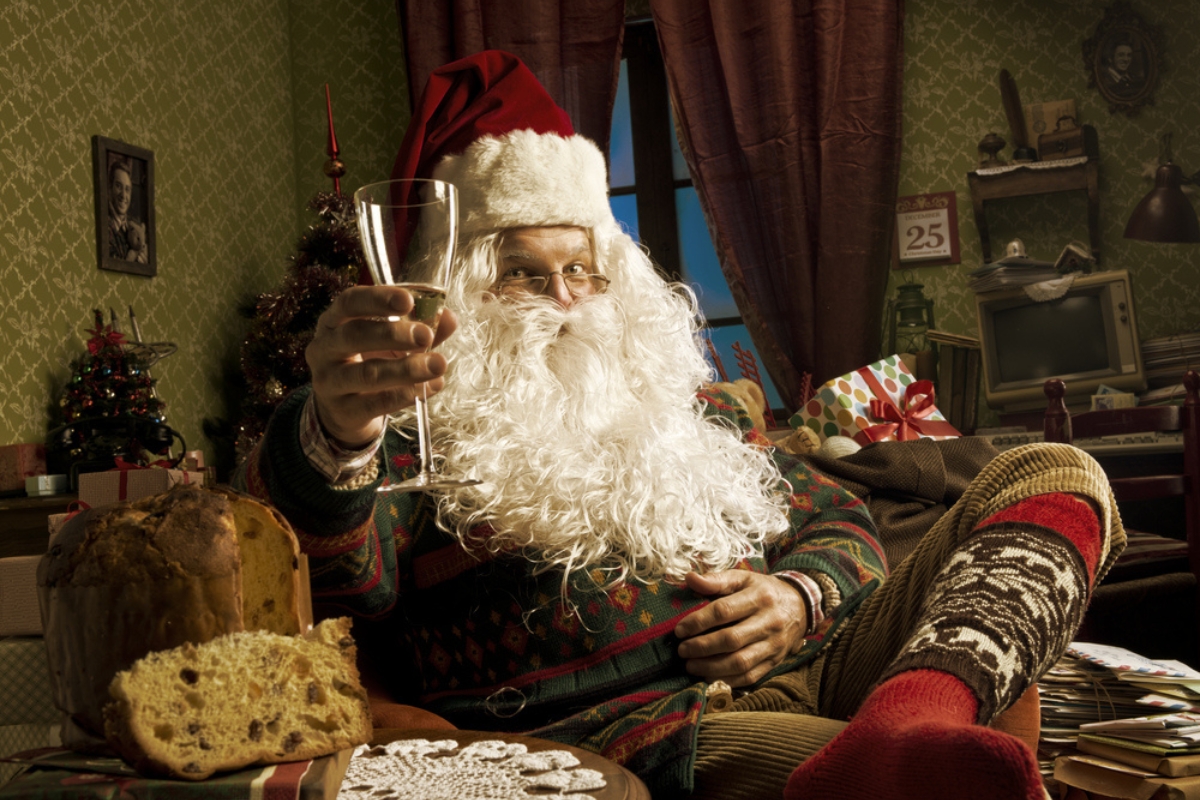 Portrait of Santa Claus celebrating with a glass of champagne