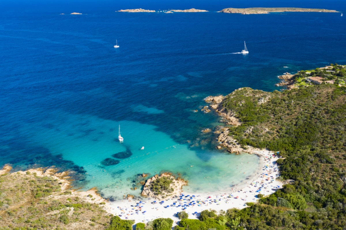 Veduta aerea di una splendida spiaggia bagnata da un mare turchese e trasparente. Spiaggia del Principe, Costa Smeralda (Sardegna), Italia