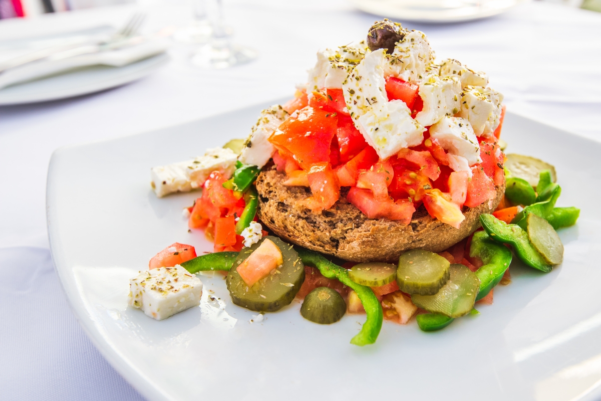 Dakos, a tasty Greek appetizer with feta cheese, olives and tomatoes