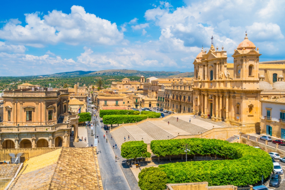 The golden baroque architecture of Noto's historic centre in Sicily, with a panoramic view of Noto Cathedral and Palazzo Ducezio