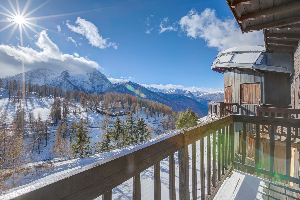 View of the snowy Italian Alps on a sunny day from Happy.Rentals' Belvedere apartments, Sestriere, Piedmont, Italy