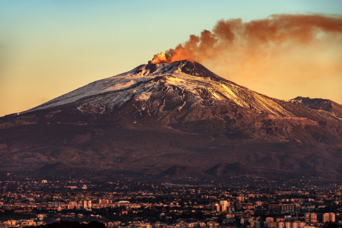 Mount Etna Volcano with smoke at dawn and the Catania city, Sicily island, Italy, Europe