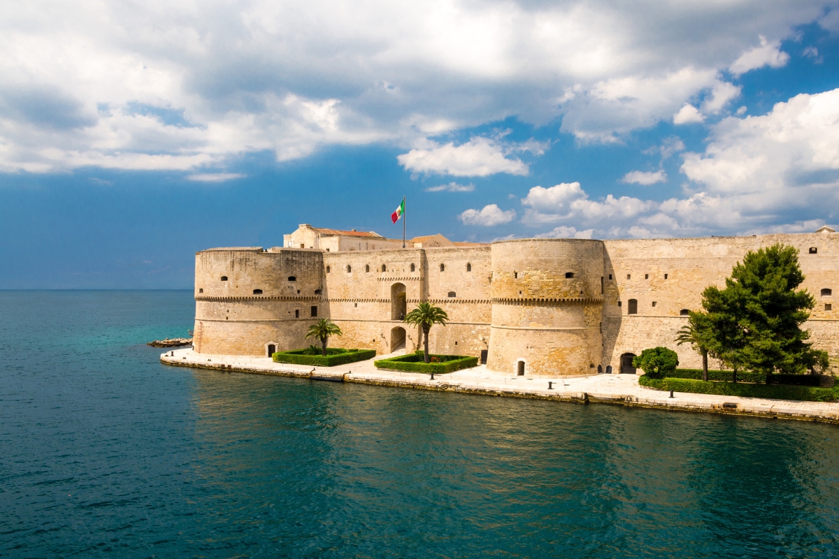 The medieval Aragonese Castle on Taranto’s seaside on a sunny but cloudy day