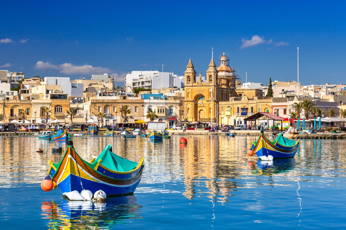 The traditional fishing boats, called luzzu, harboured in the village of Marsaxlokk  on a sunny day