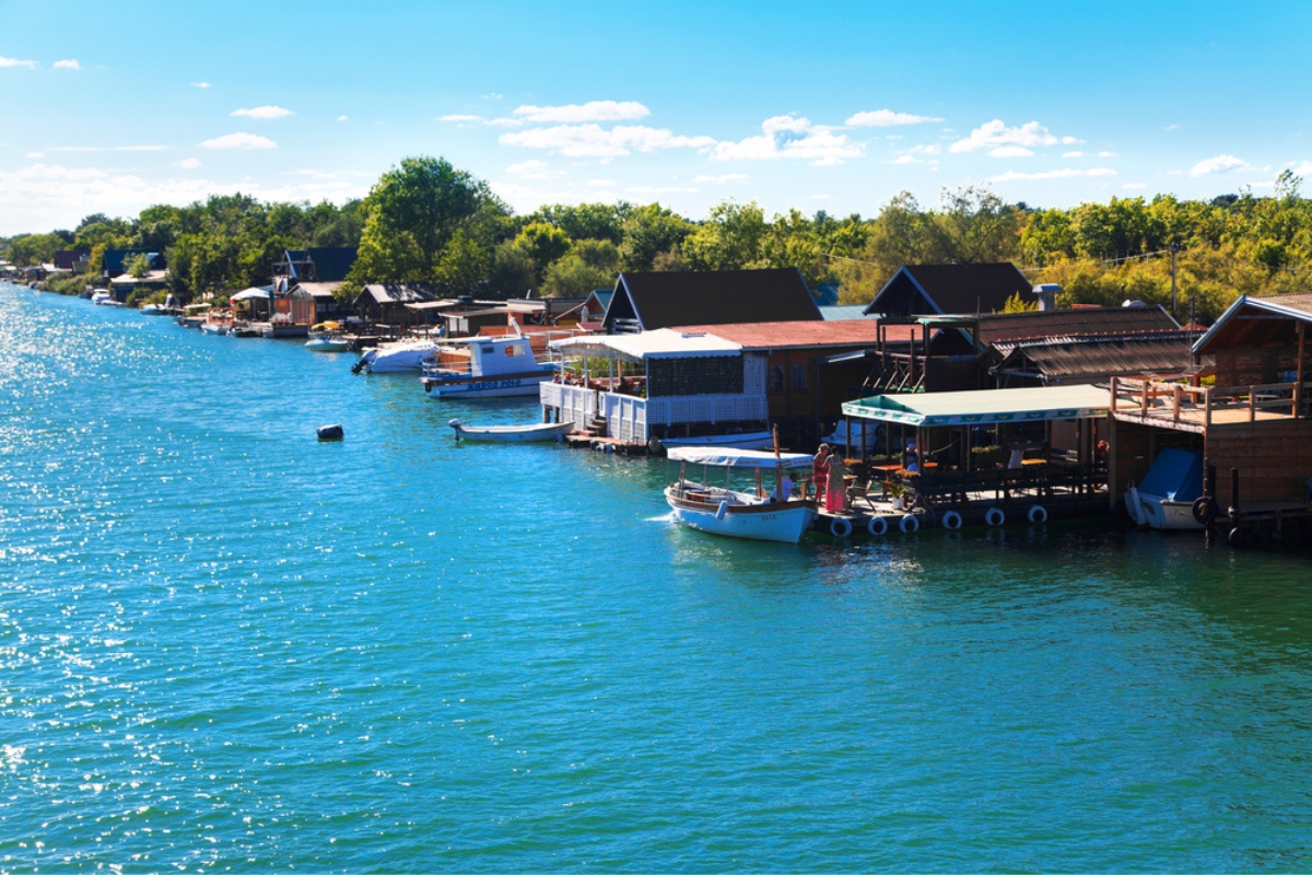 Ada Boiana is an island created by a river delta of the Bojana River and is a popular tourist destination with long sandy beach and traditional seafood restaurants