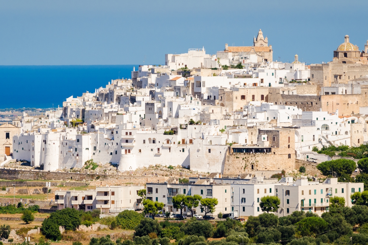 The white town of Ostuni with the blue sea in the background 