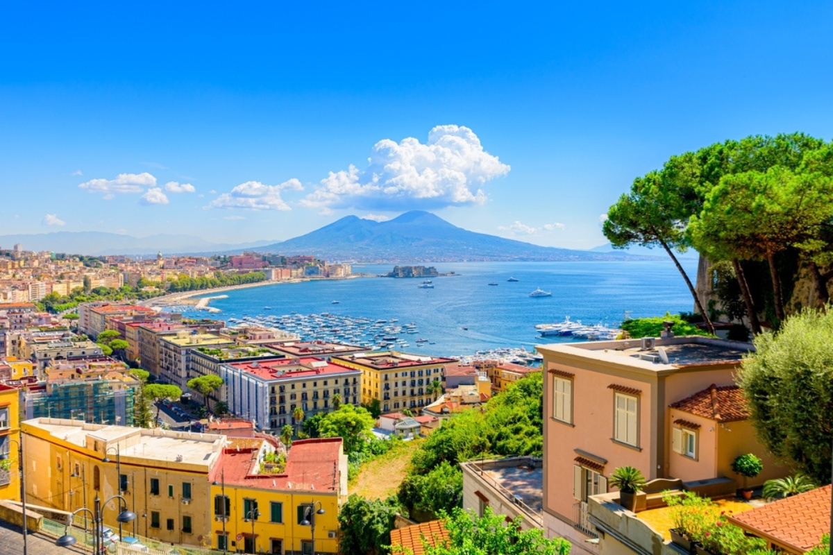 Naples, Italy. View of the Gulf of Naples from the Posillipo hill with Mount Vesuvius far in the background and some pine trees in foreground